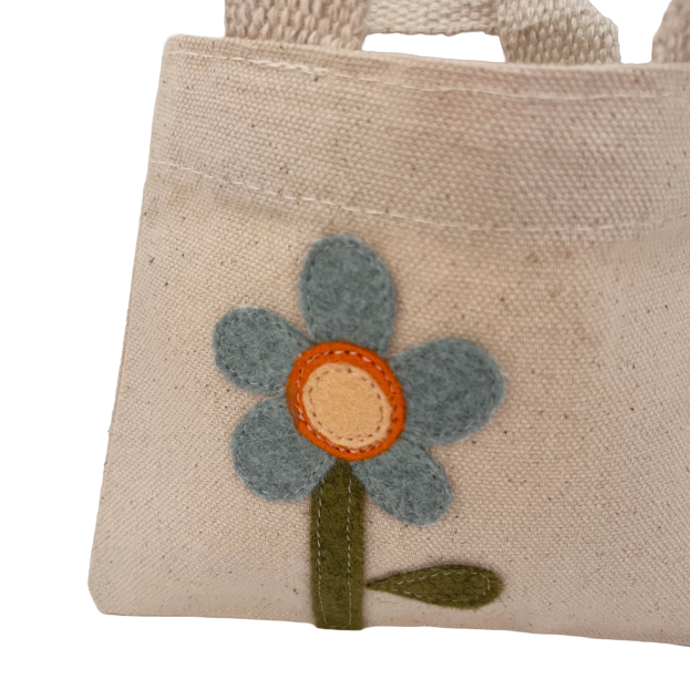 Small beige bag with a flower design on a white background