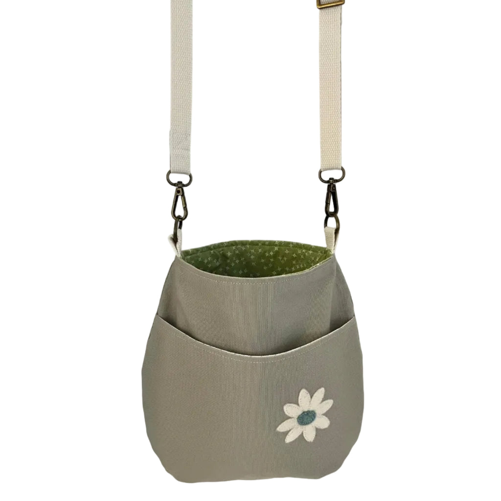 Green and gray bag with a flower design on a white background