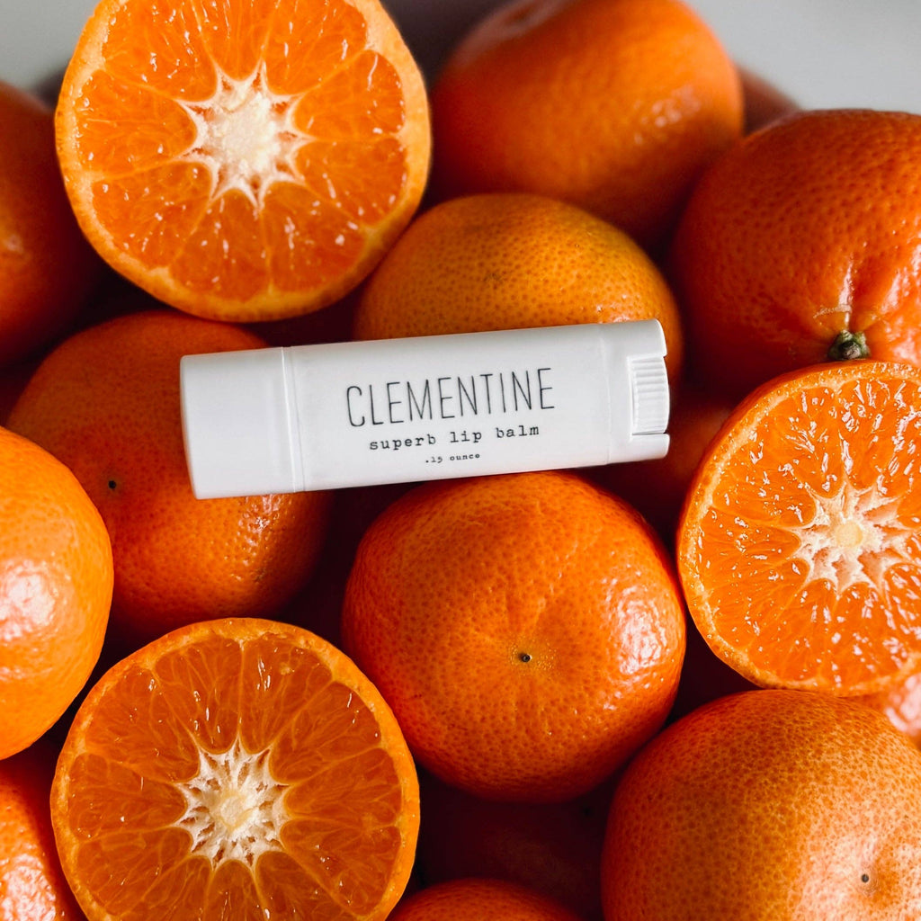 Lip balm labeled 'Clementine' on a pile of clementines