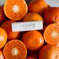 Lip balm labeled 'Clementine' on a pile of clementines