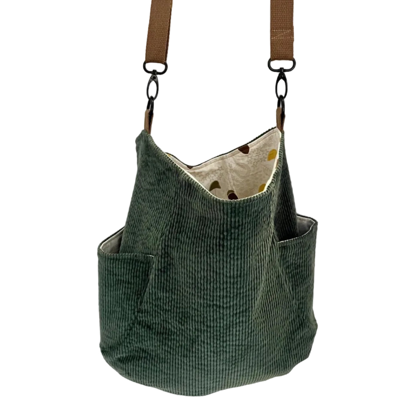 Green corduroy bag with a brown strap on a white background