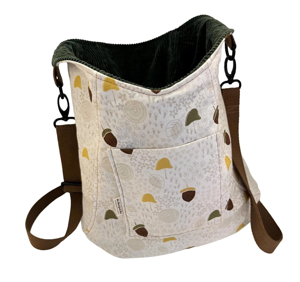 Bag with acorn pattern and brown straps on a white background