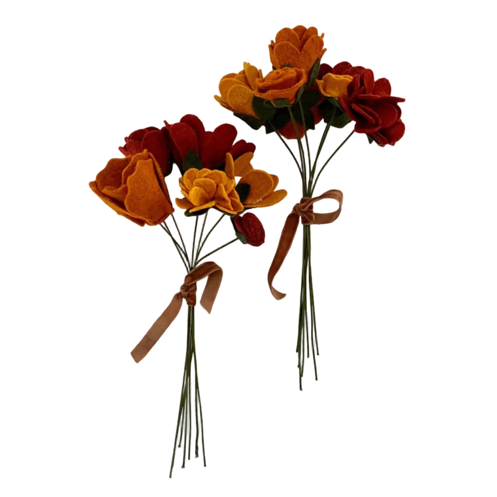 Bouquet of autumn-colored artificial flowers with ribbons on a white background