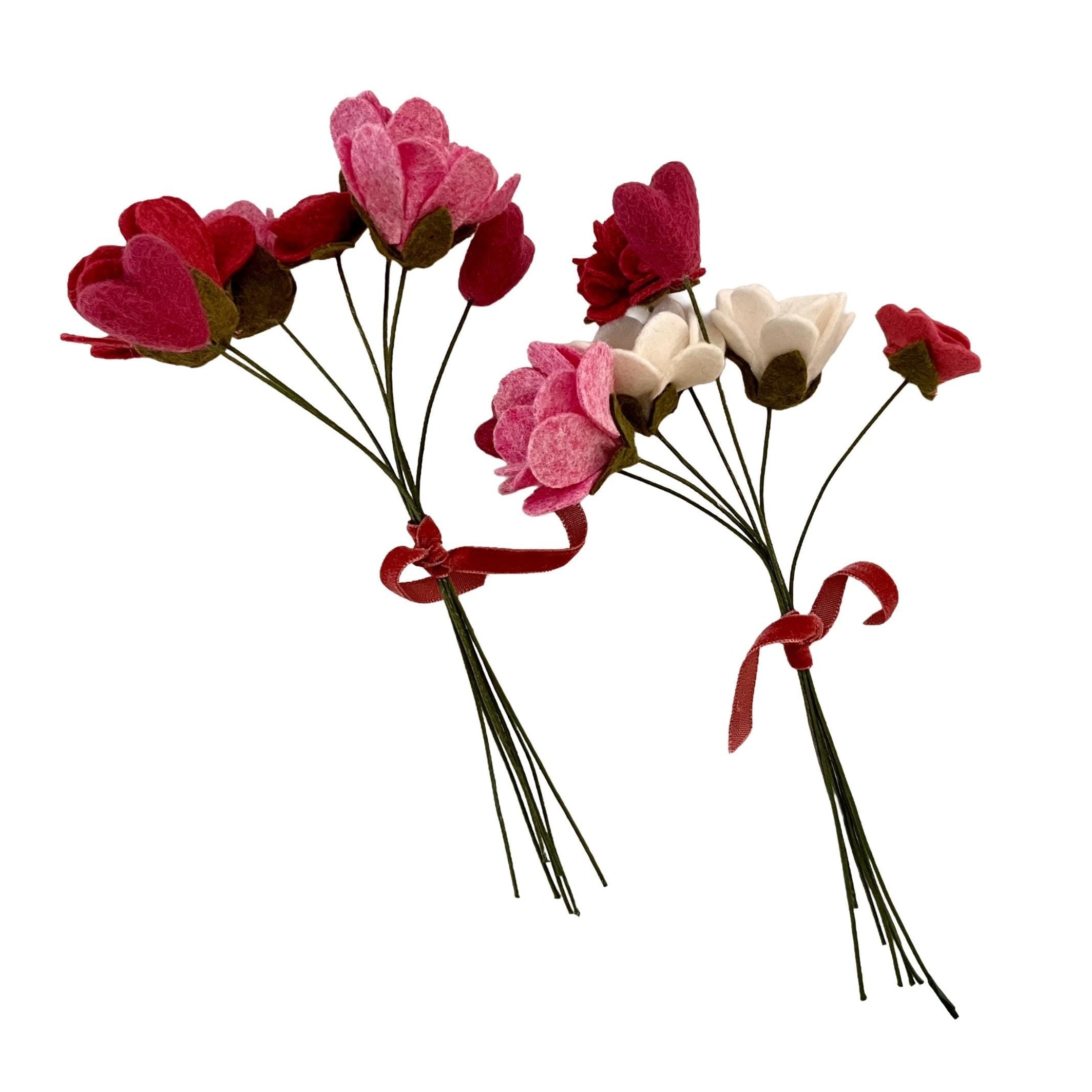Two bouquets of artificial flowers with red ribbons on a white background