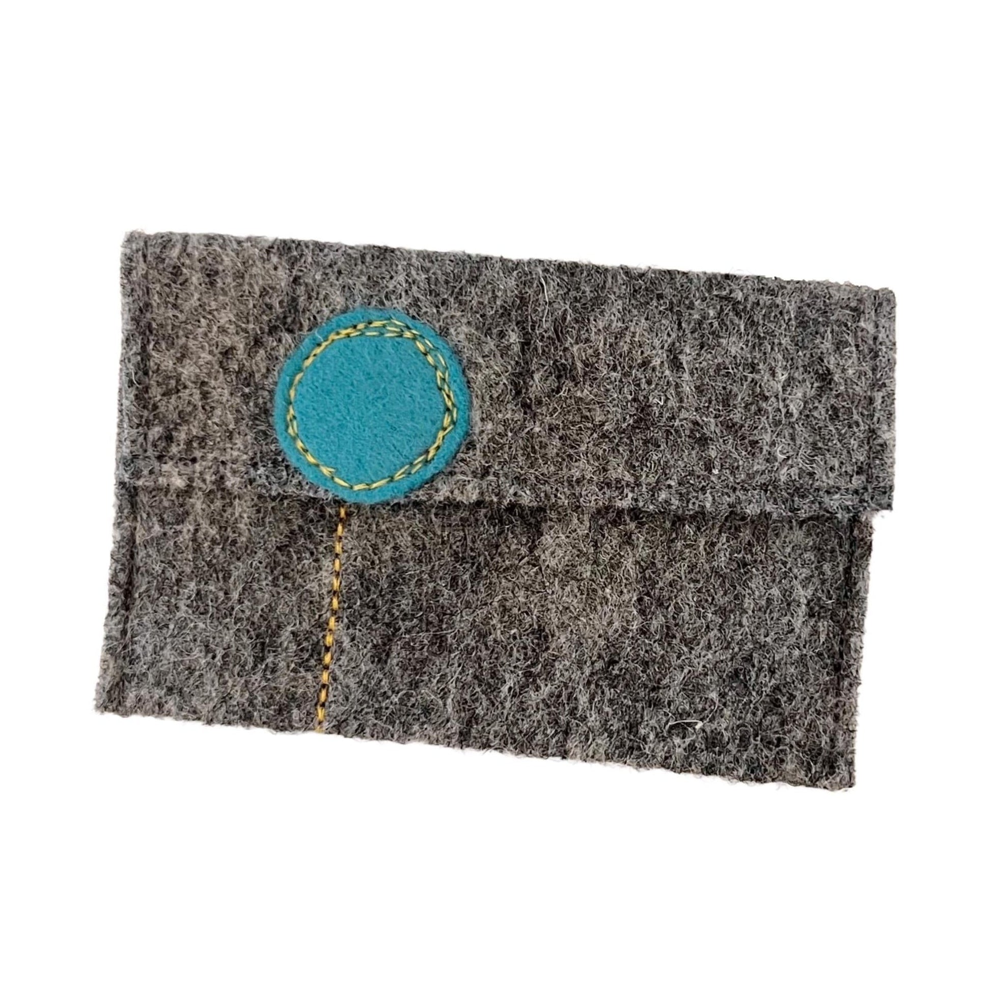 Gray felt pouch with a blue circular patch on a white background