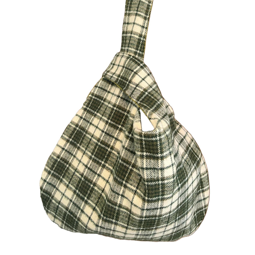 Plaid handbag with a strap on a white background