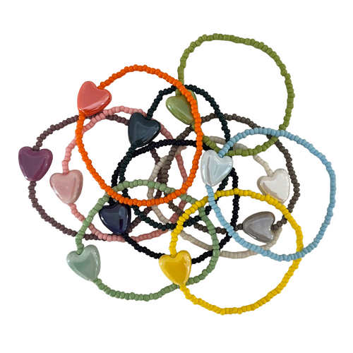 Colorful heart-shaped bracelets on a white background