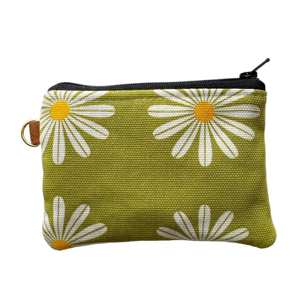 Small green pouch with white daisy patterns on a light gray background