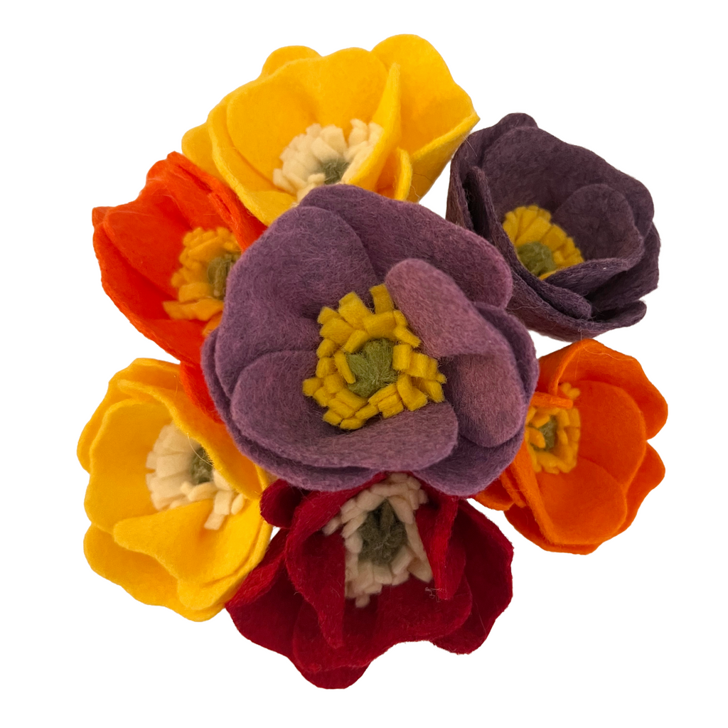 Colorful felt flowers on a white background