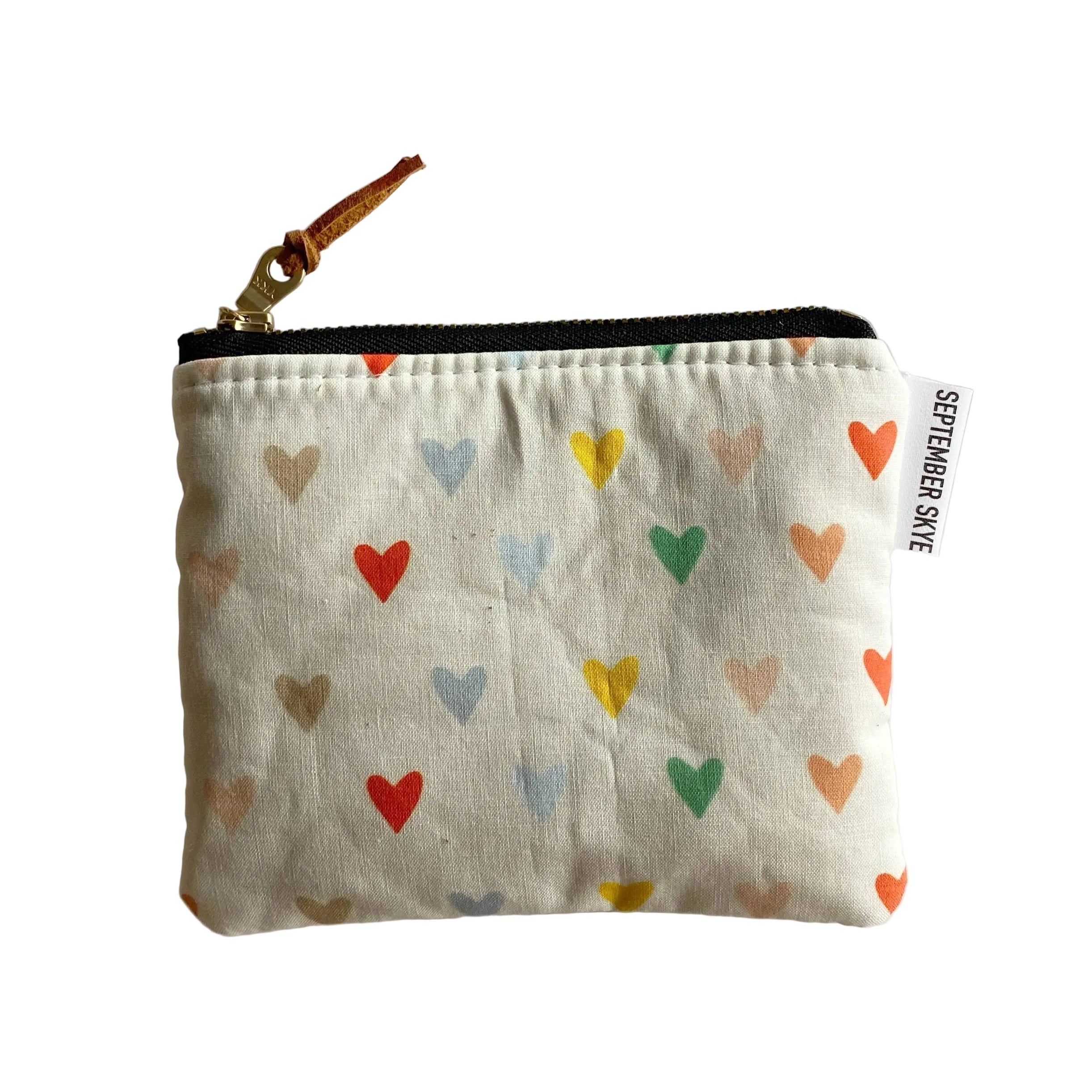 Small pouch with colorful heart pattern on a white background