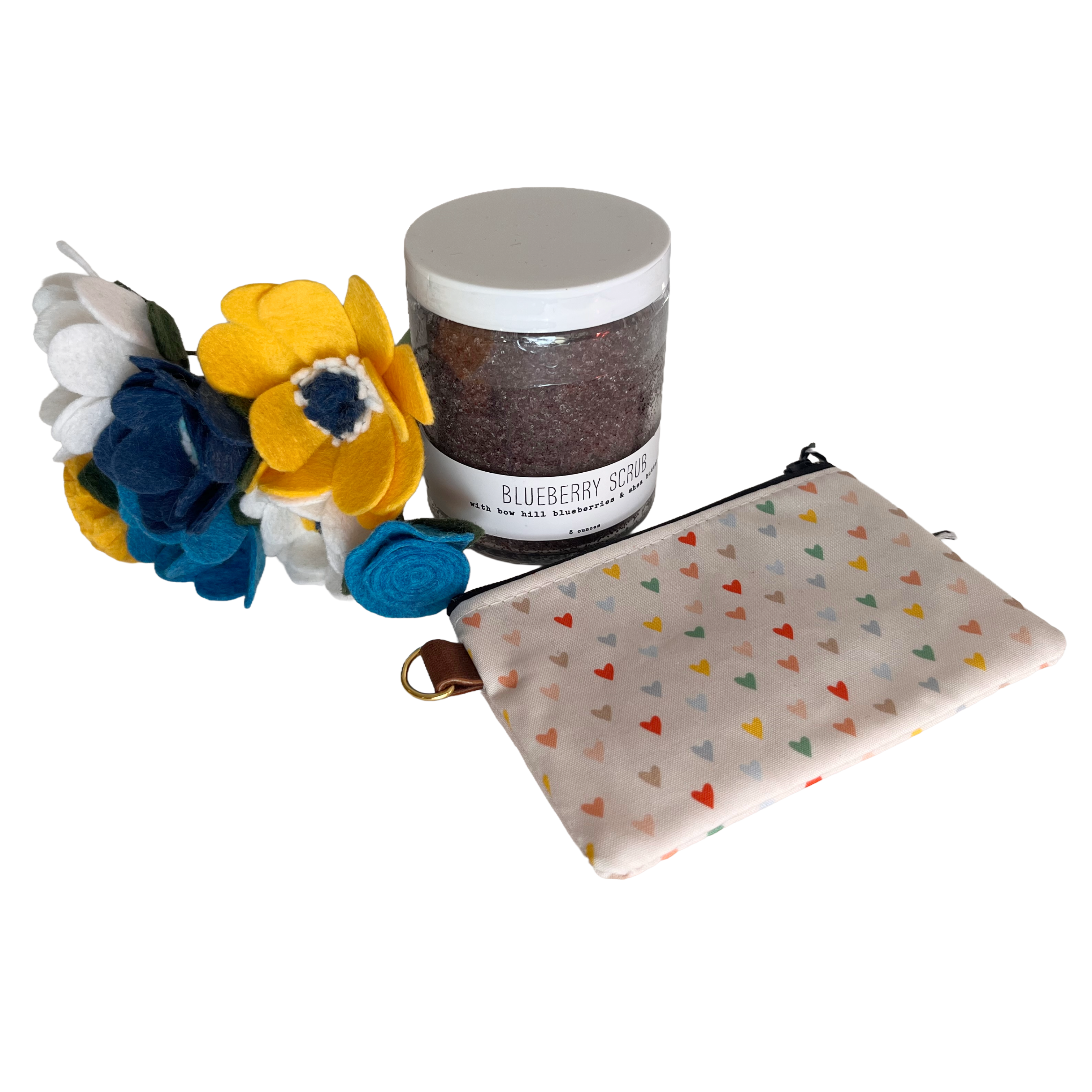 Jar of blueberry scrub, felt flower bouquet, and coin pouch with heart pattern on a white background
