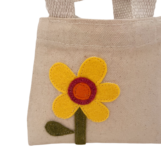 Beige fabric bag with a yellow flower design on a white background