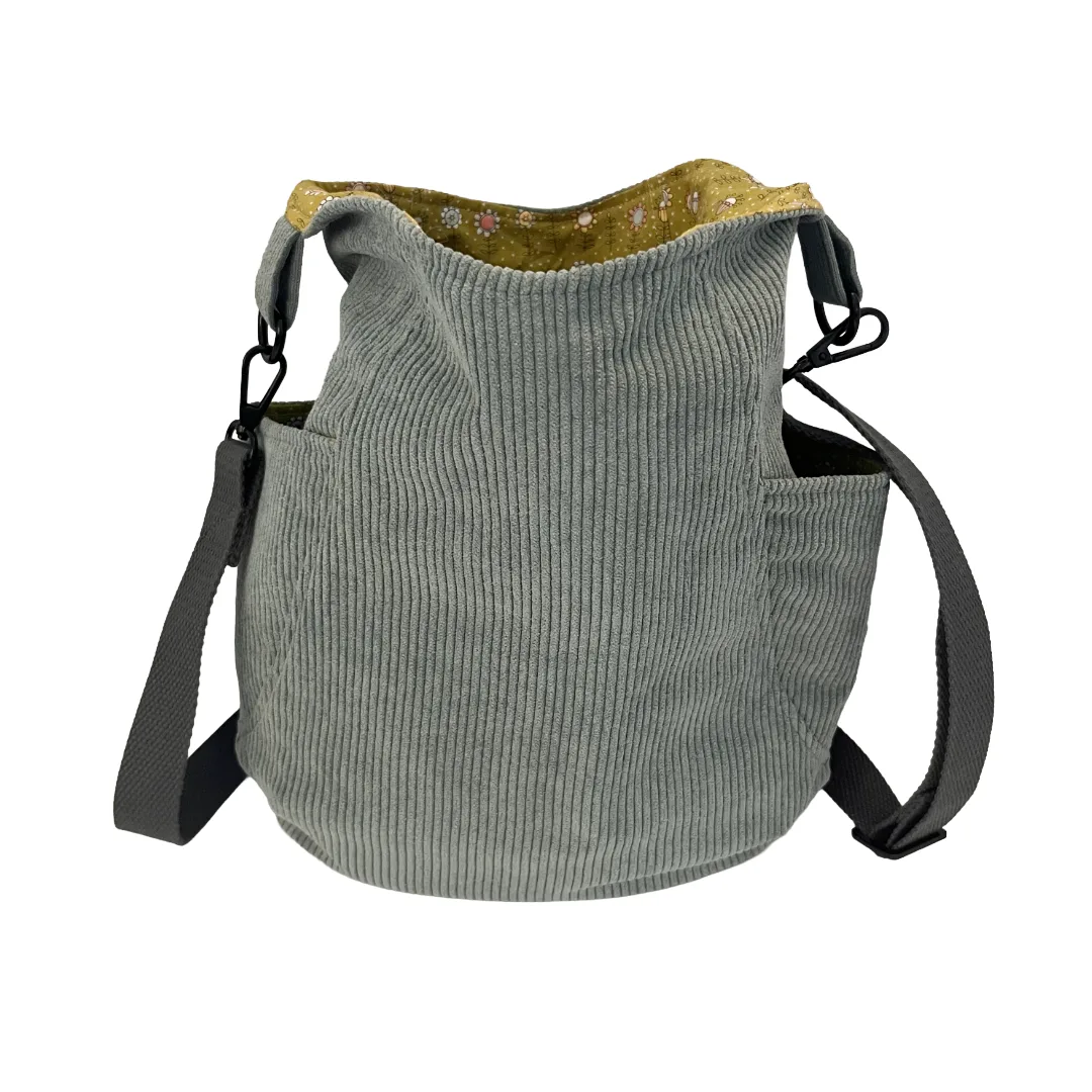 Blue corduroy bag with a strap on a white background