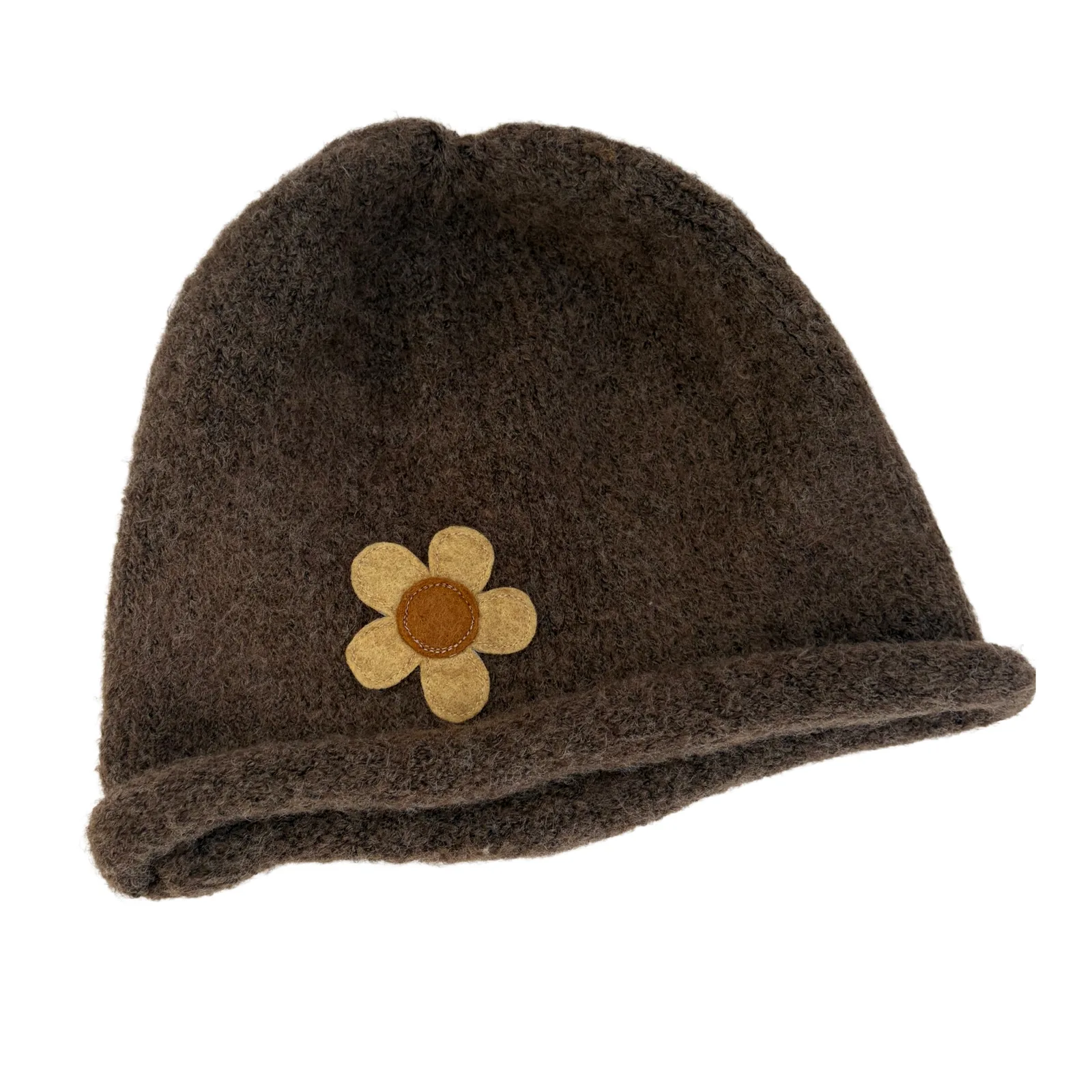 A dark brown fuzzy knit beanie hat featuring a small tan and brown flower applique on the front, set against a plain white background.