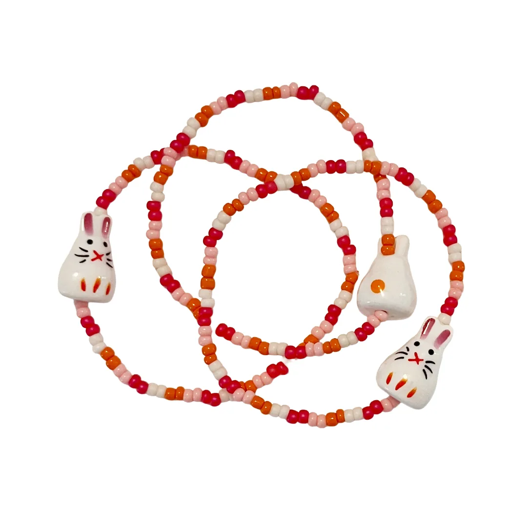 Group of beaded bracelets with rabbits on a white background