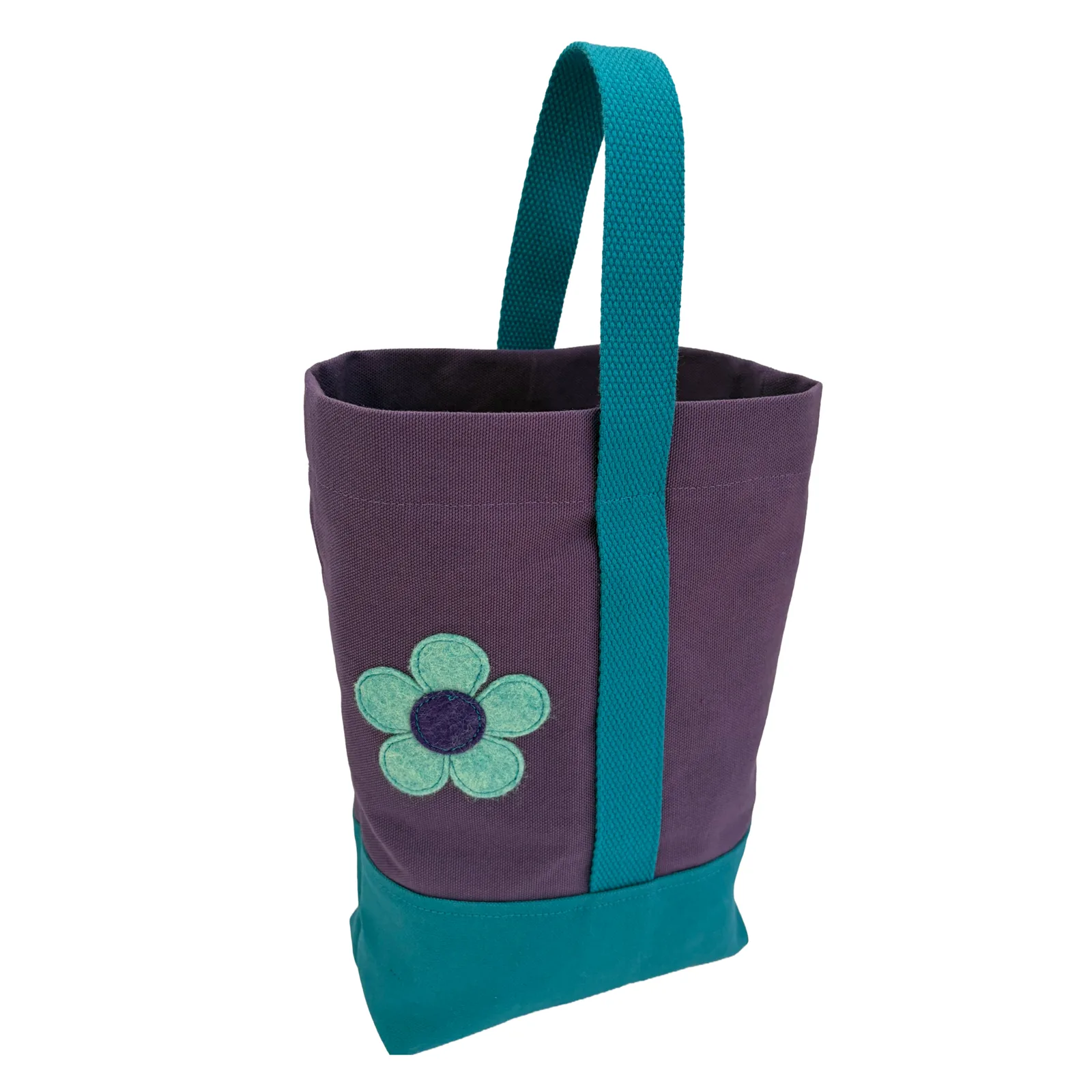 A purple canvas wine tote bag with teal fabric handles and a matching teal bottom base, featuring an embroidered light mint flower with a dark purple center on the front.