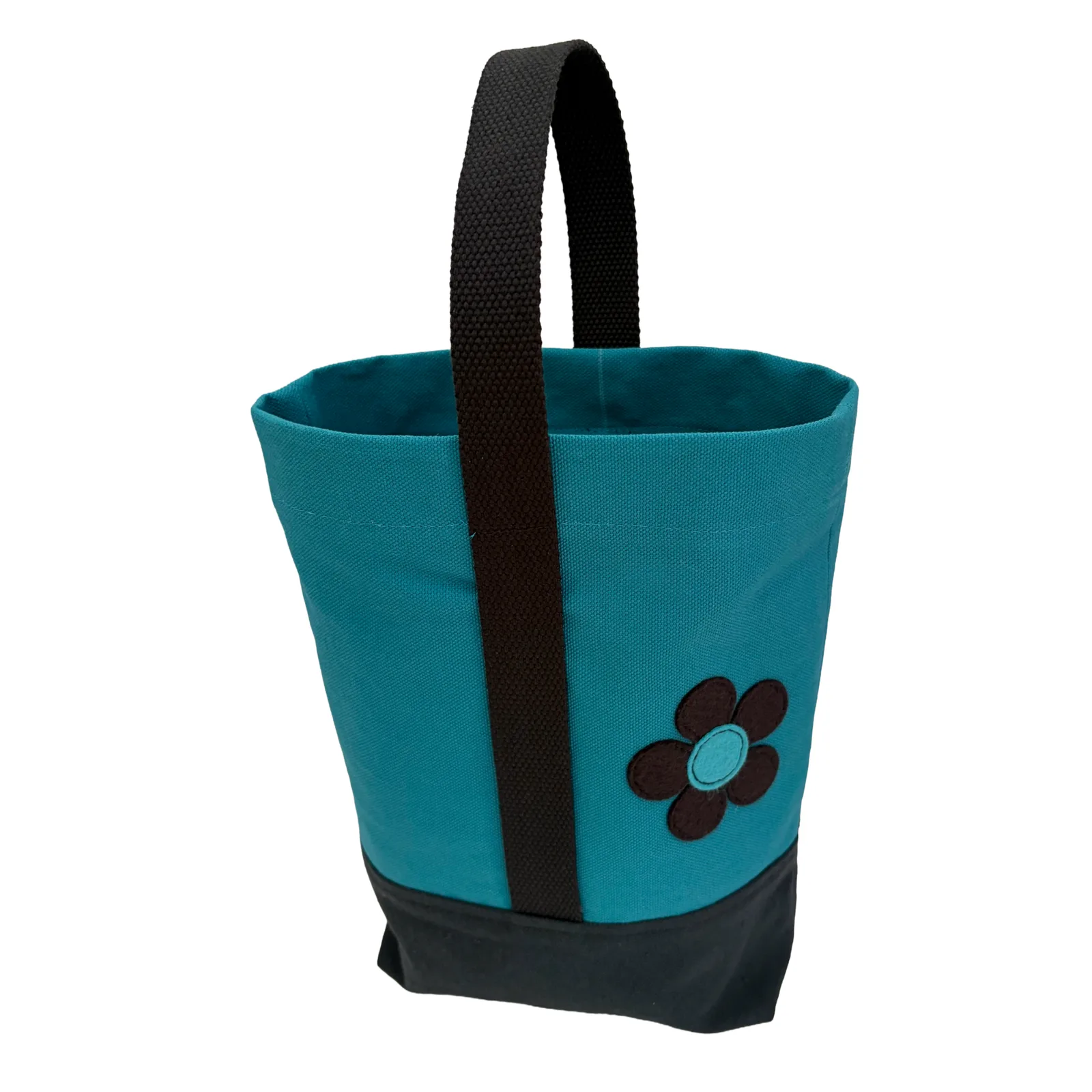 A teal canvas wine tote bag with a black handle, a black bottom base, and a navy flower applique on the front.