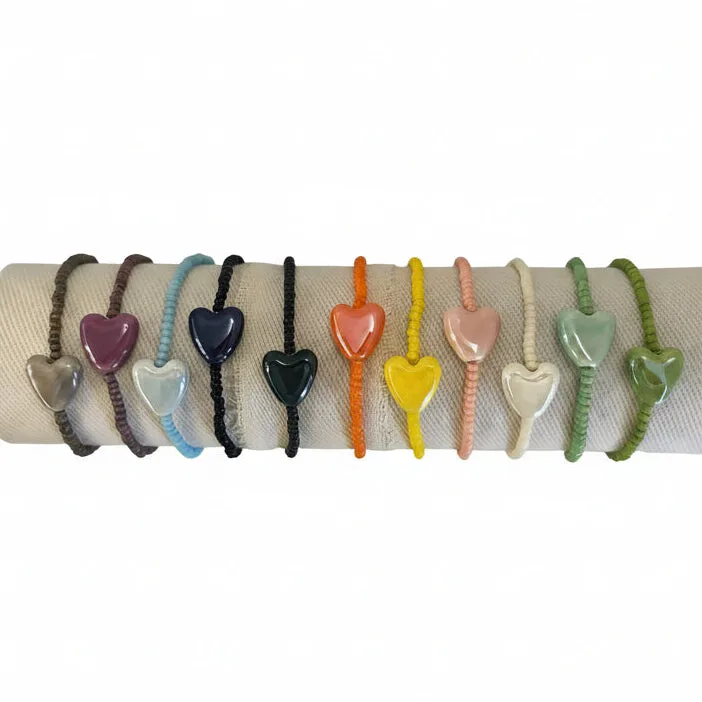 Set of colorful heart-shaped bracelets on a white background