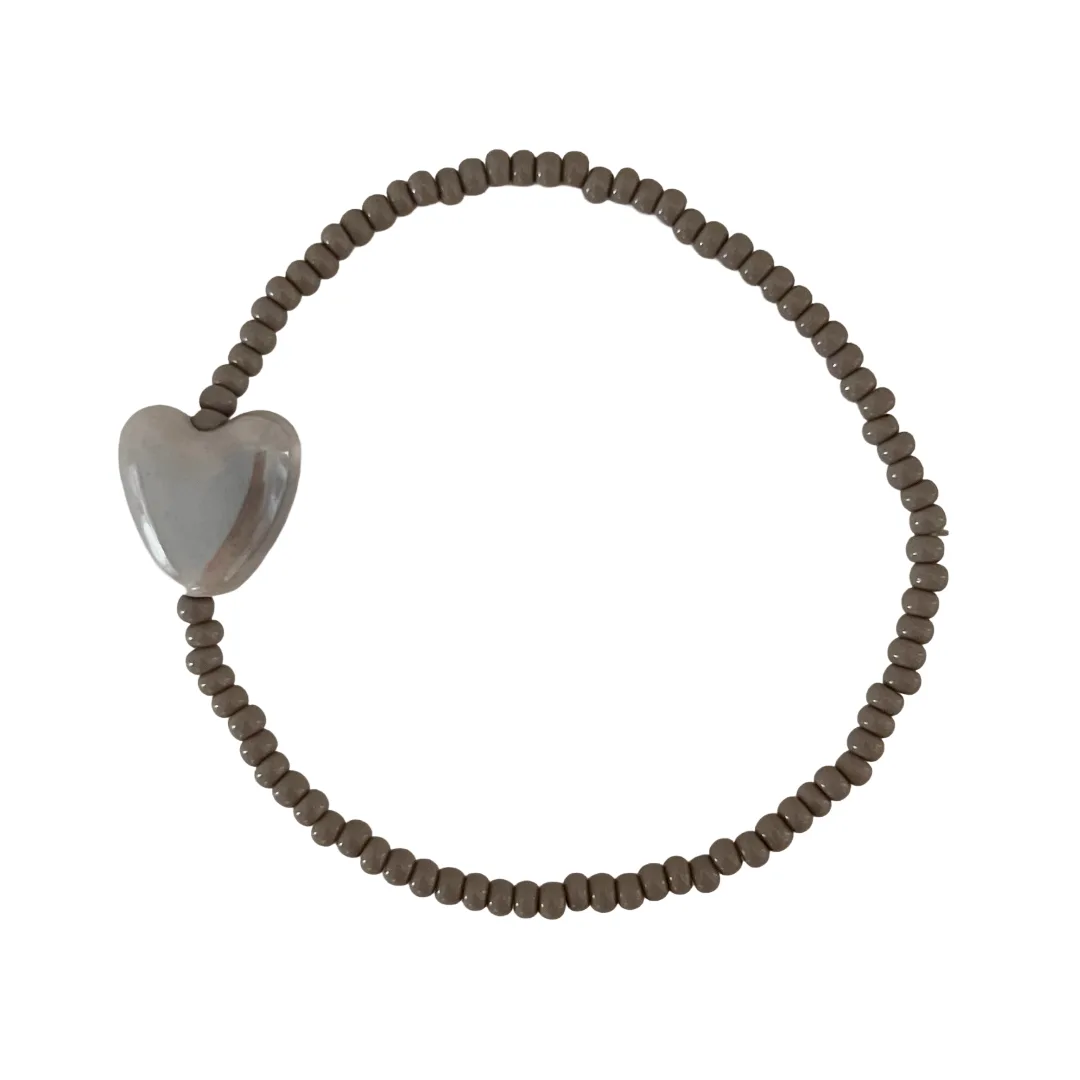 Gray beaded bracelet with a heart-shaped charm on a white background