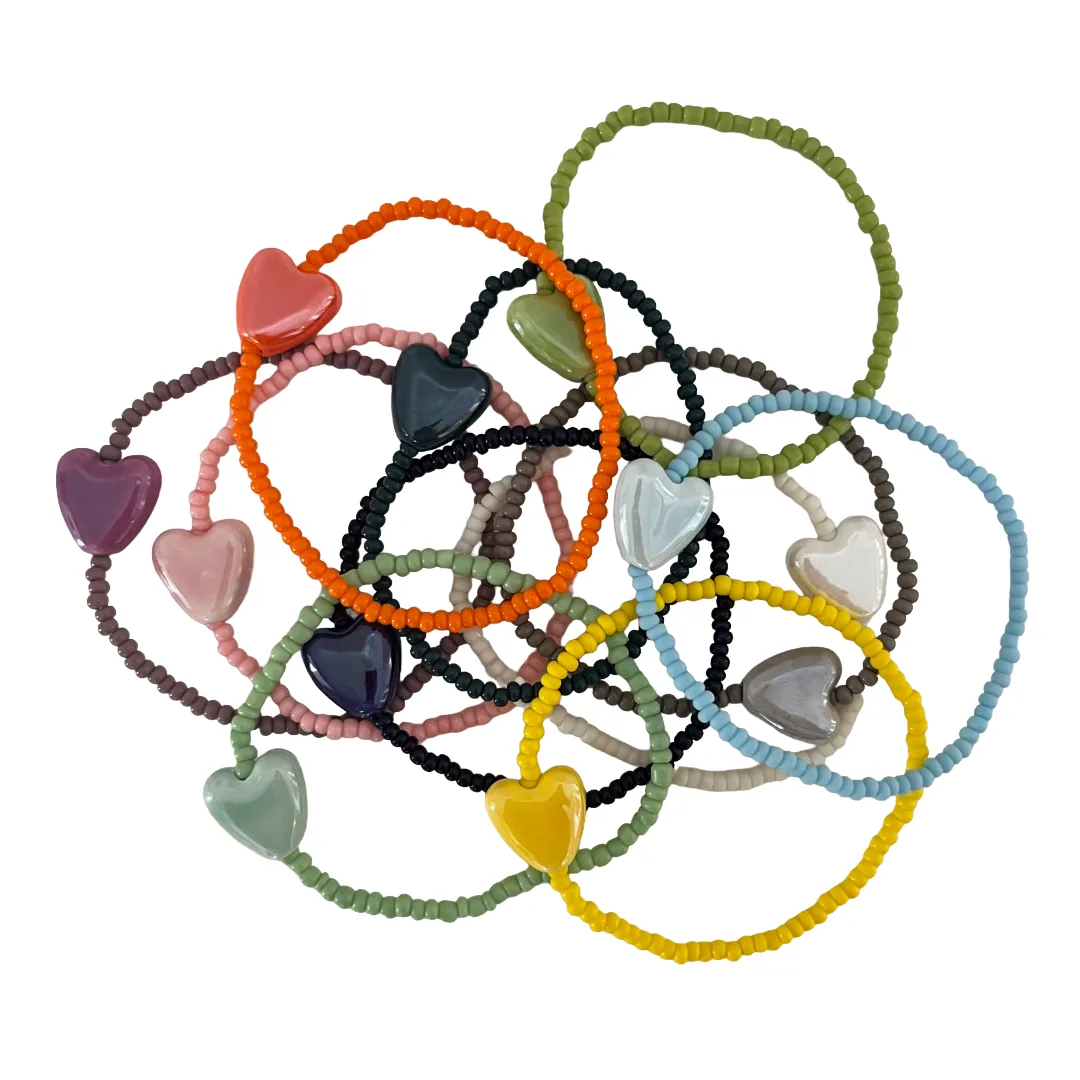 Colorful heart-shaped bracelets on a white background