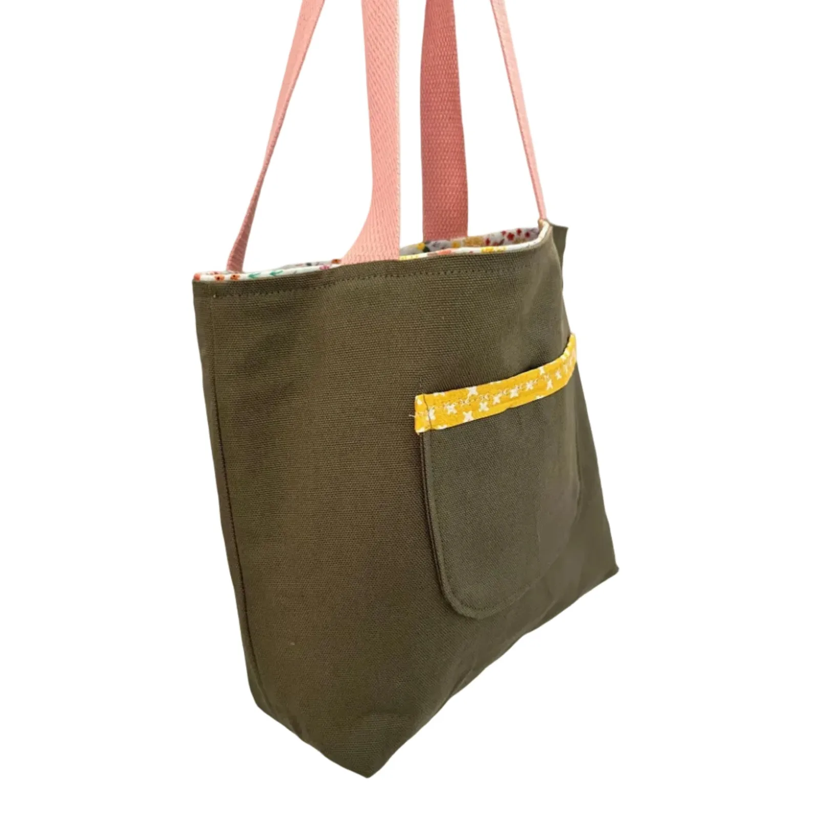 Green tote bag with a yellow pocket and pink straps on a white background