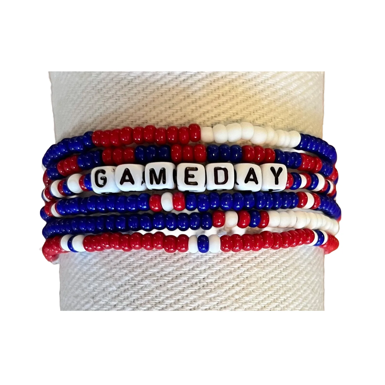 Stack of red, royal blue and white seed bead bracelets with a GAMEDAY letter bracelet