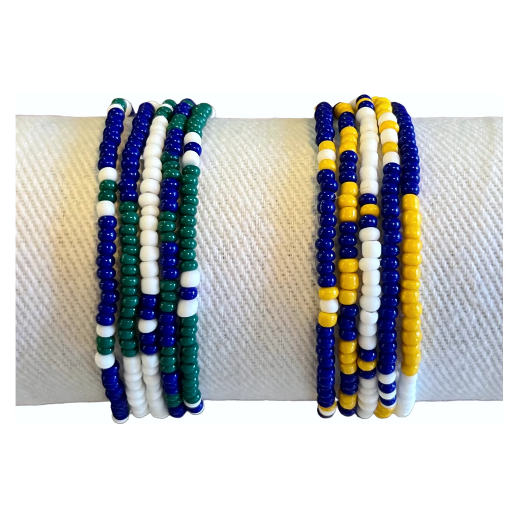 Two stacks of five seed bead bracelets: royal blue, green and white, and royal blue, yellow and white