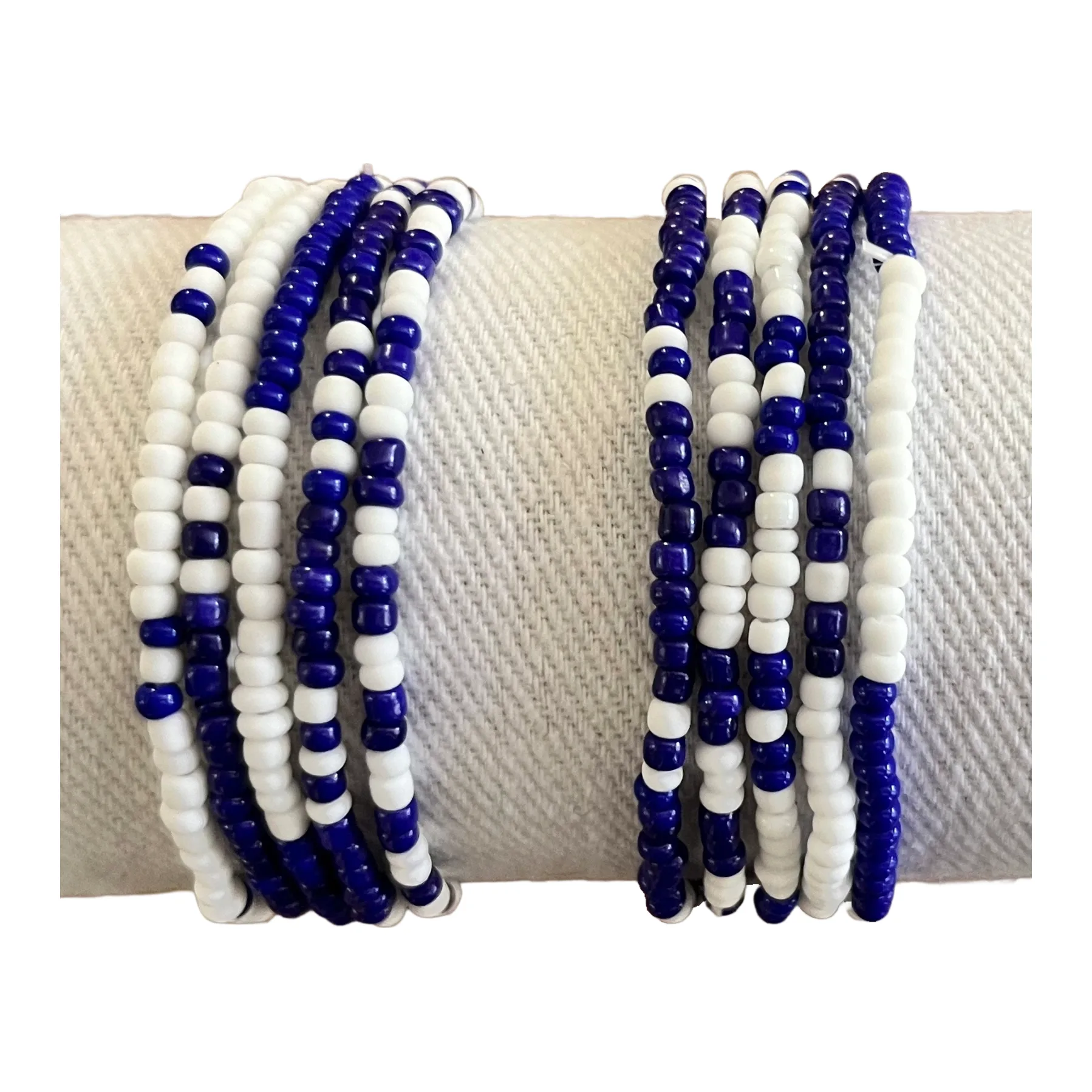 Two stacks of royal blue and white seed bead bracelets