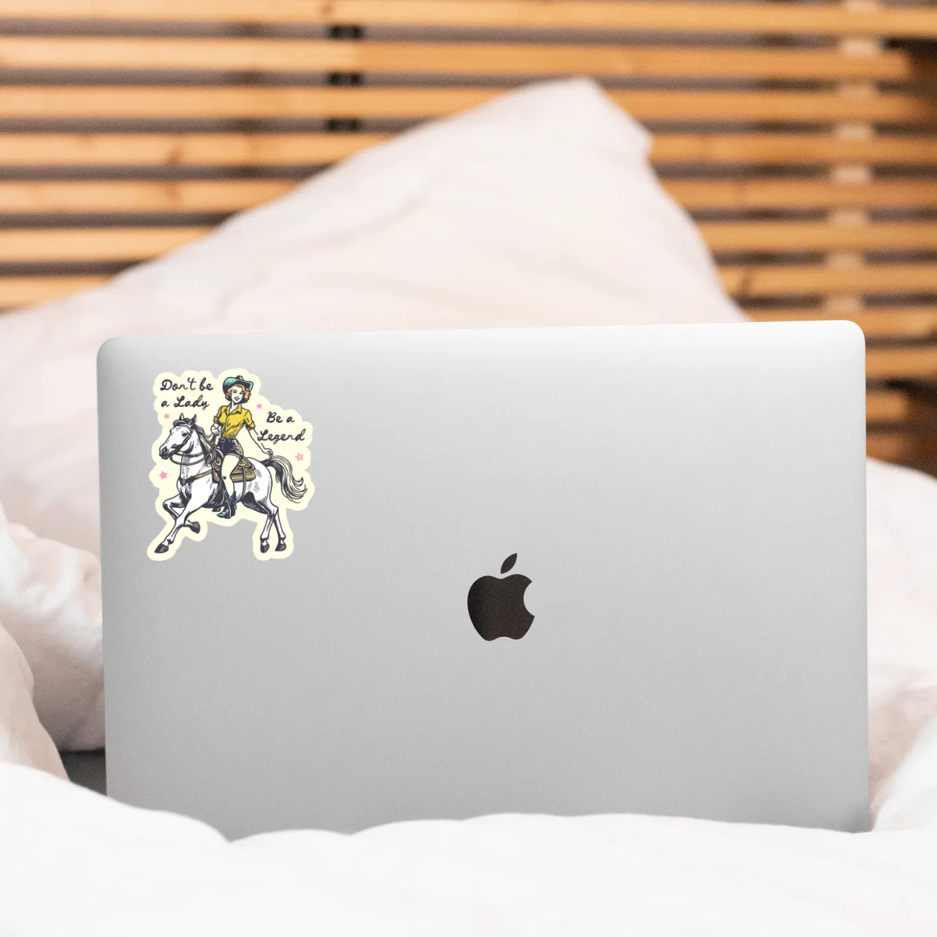 Laptop with a sticker on a bed