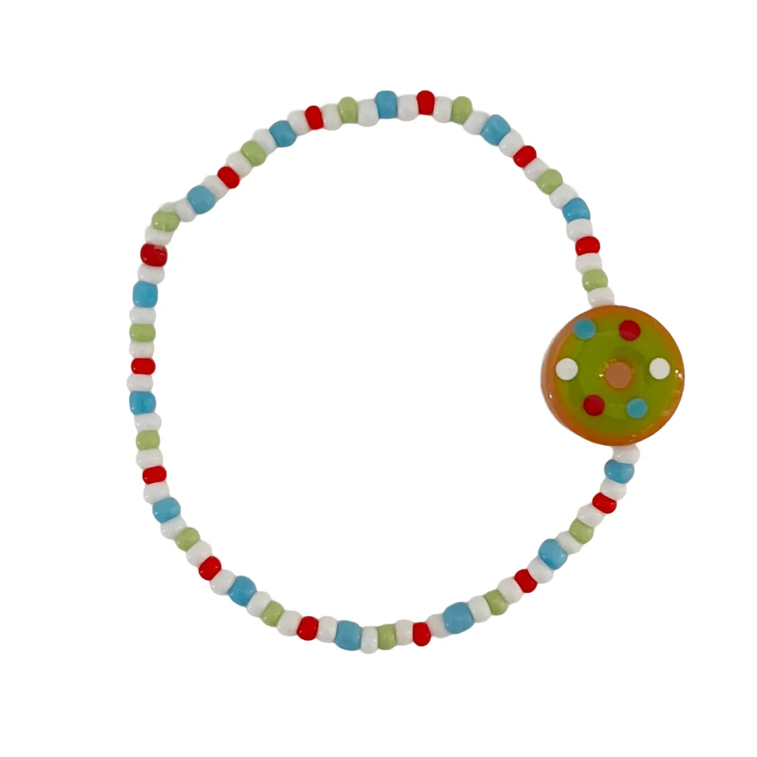 Colorful beaded bracelet with a donut bead on a white background