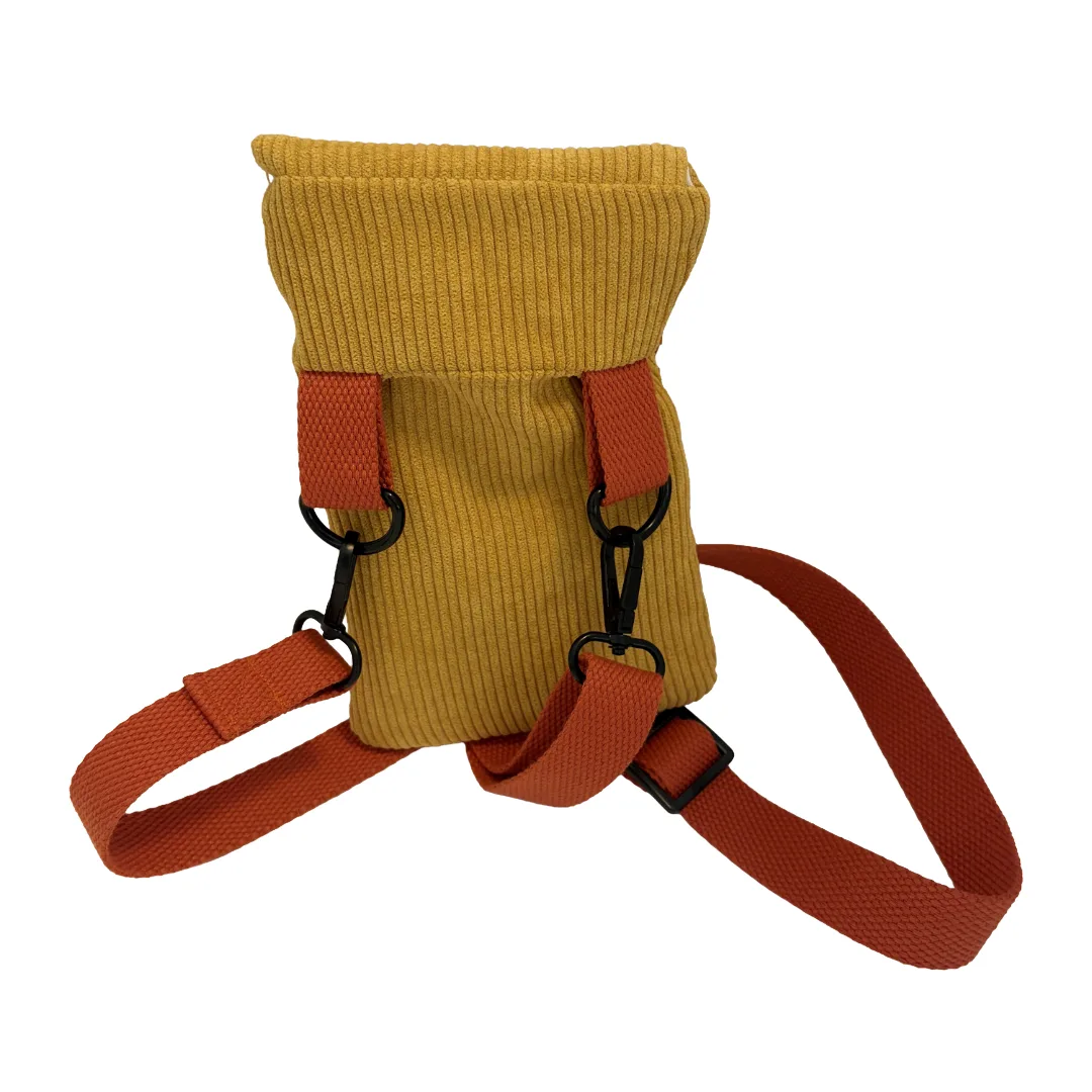 A mustard yellow corduroy pouch with orange-brown webbed straps and black metal clips, shown on a plain white background.
