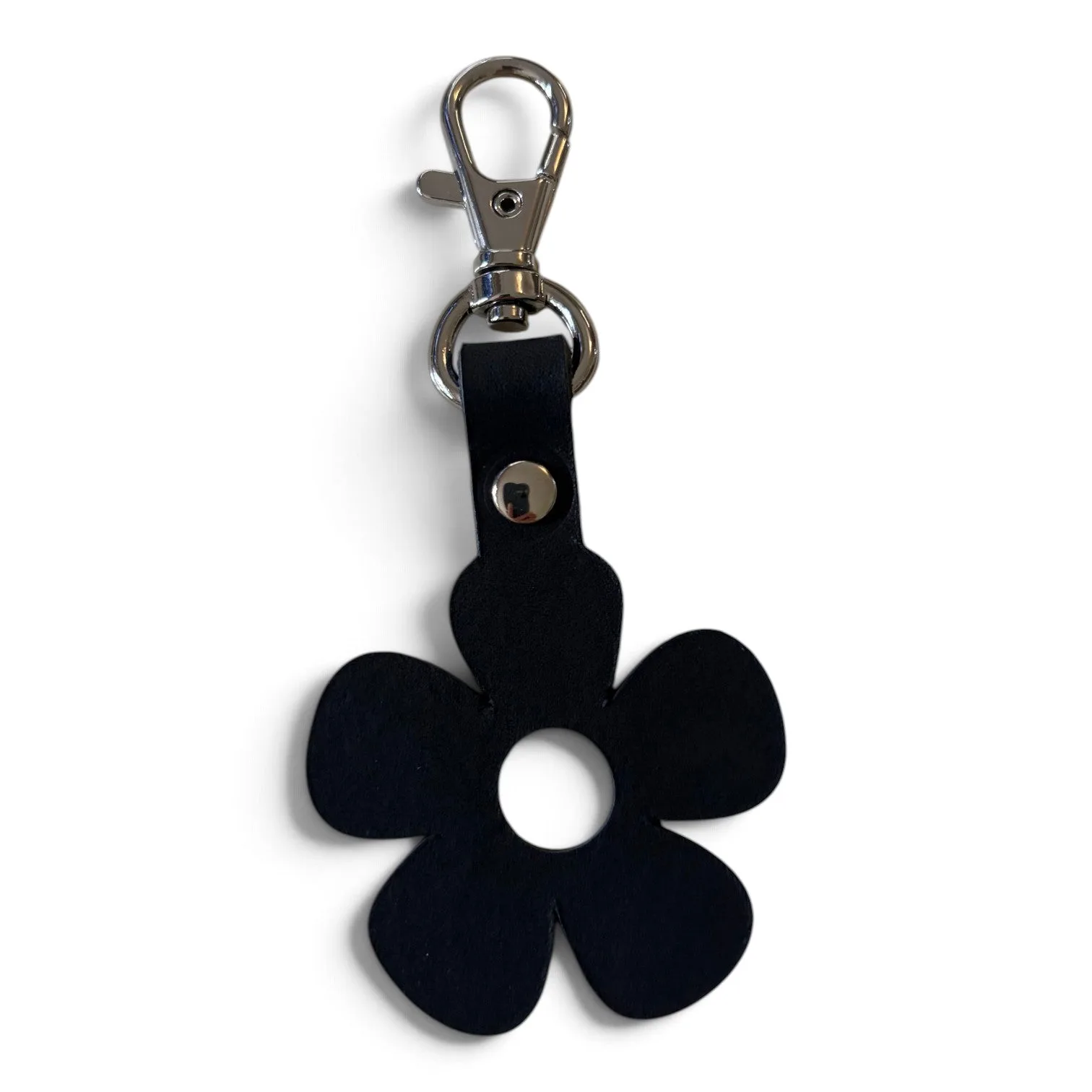 A black five-petal flower-shaped keychain with a silver metal clasp, photographed on a plain white background.
