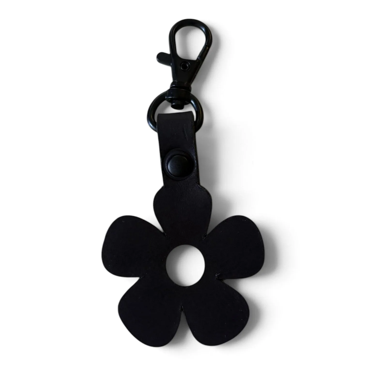 A black flower-shaped keychain or bag charm with a metal clasp, shown on a plain white background.