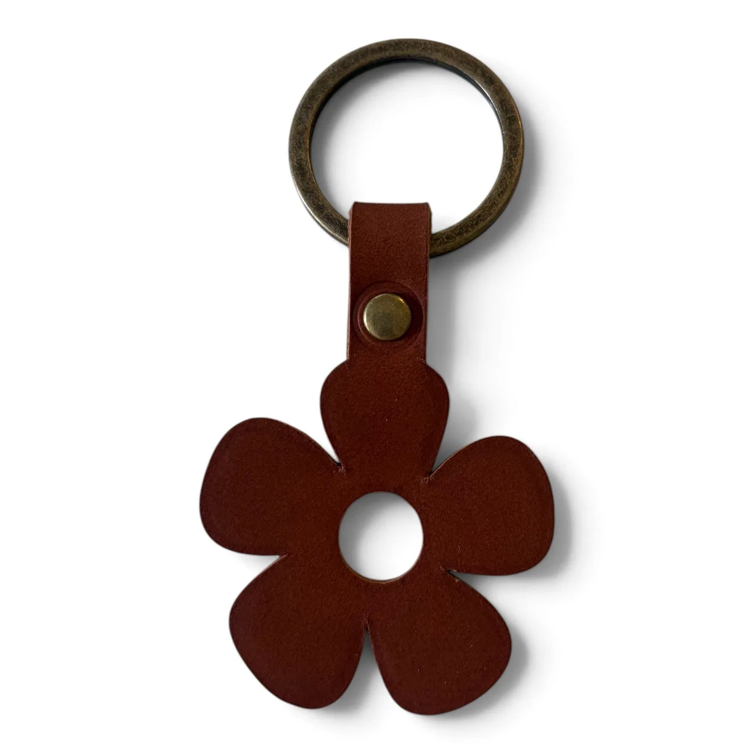 A dark brown leather keychain featuring a five-petal flower cutout and a round metal key ring, shown on a plain white background.