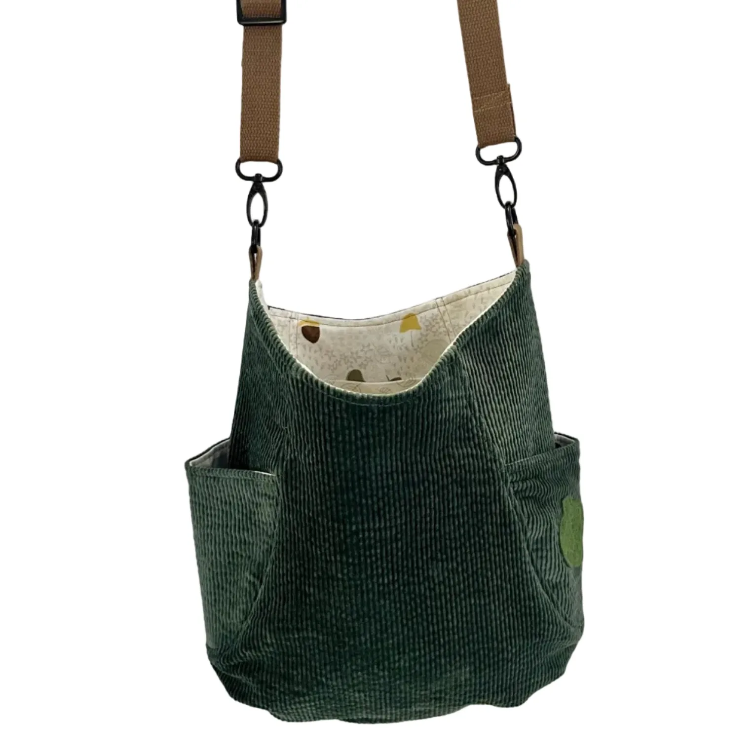 Green corduroy bag with a strap on a white background