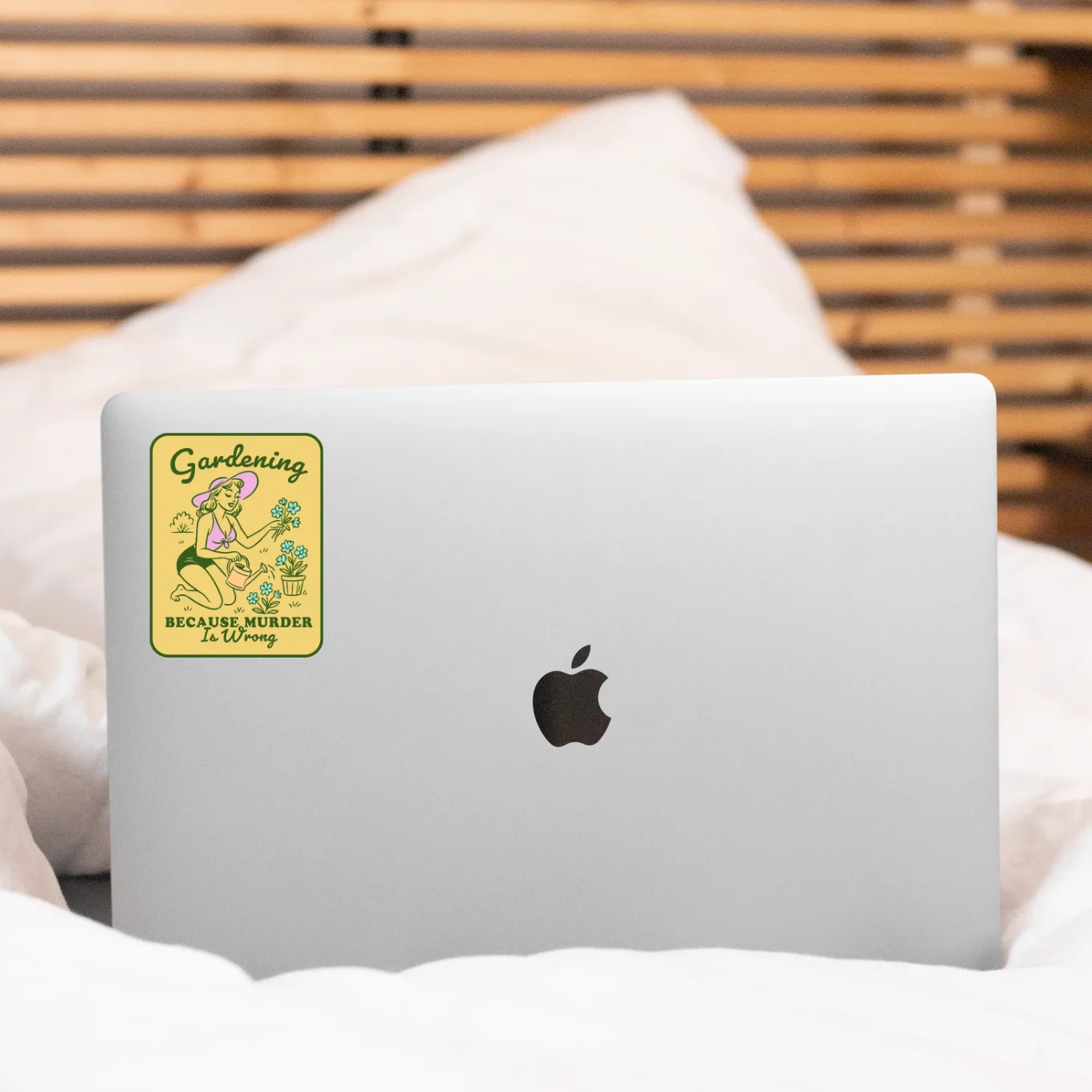 Laptop with a sticker on a bed