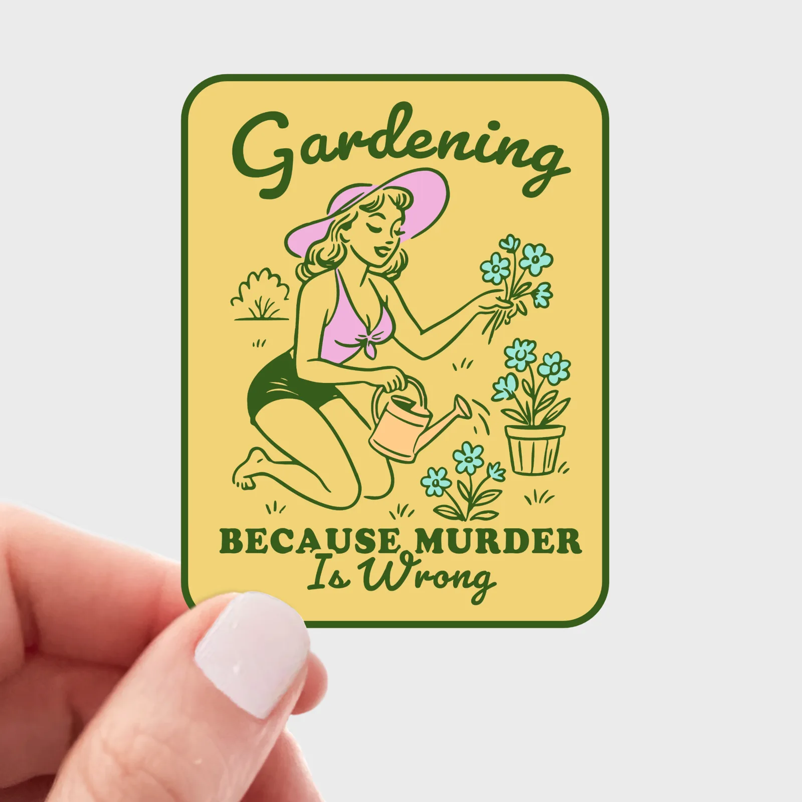 Sticker with a design of a woman gardening and text 'Gardening Because Murder Is Wrong' held by a hand.