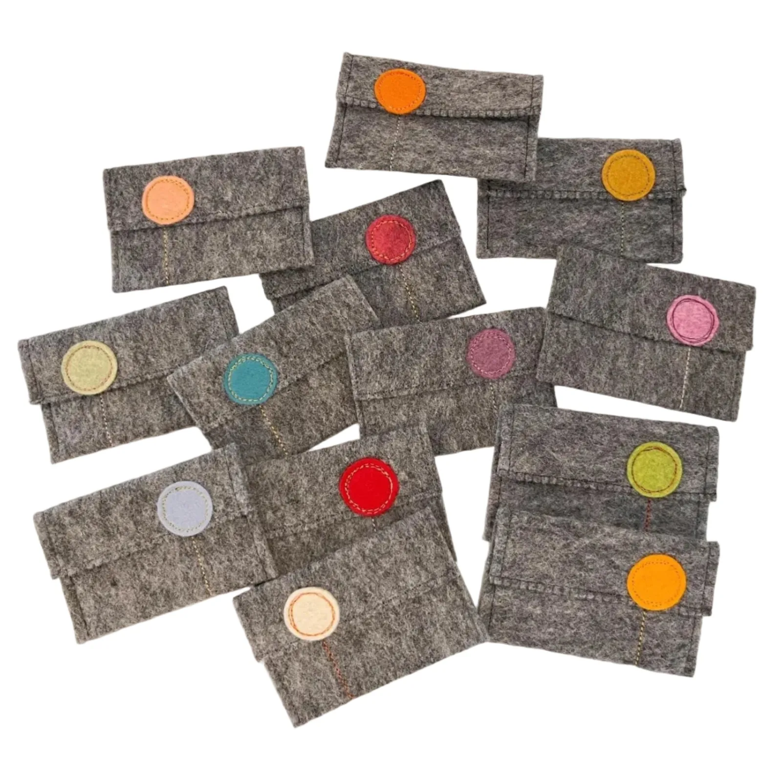 Set of small gray felt pouches with colorful circular accents on a white background