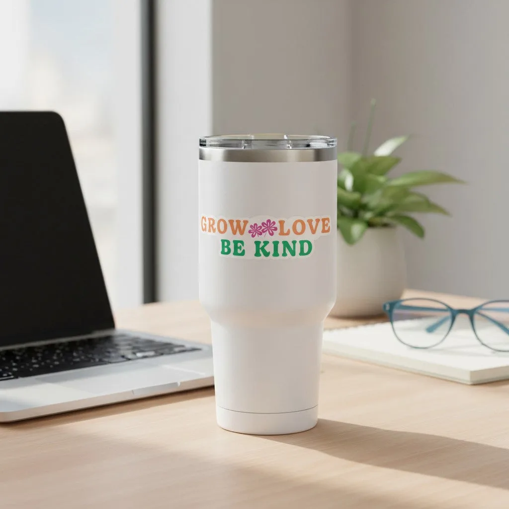 Be Kind Goods Grow Love Be Kind vinyl sticker on a white tumbler on a desk with a laptop and plant
