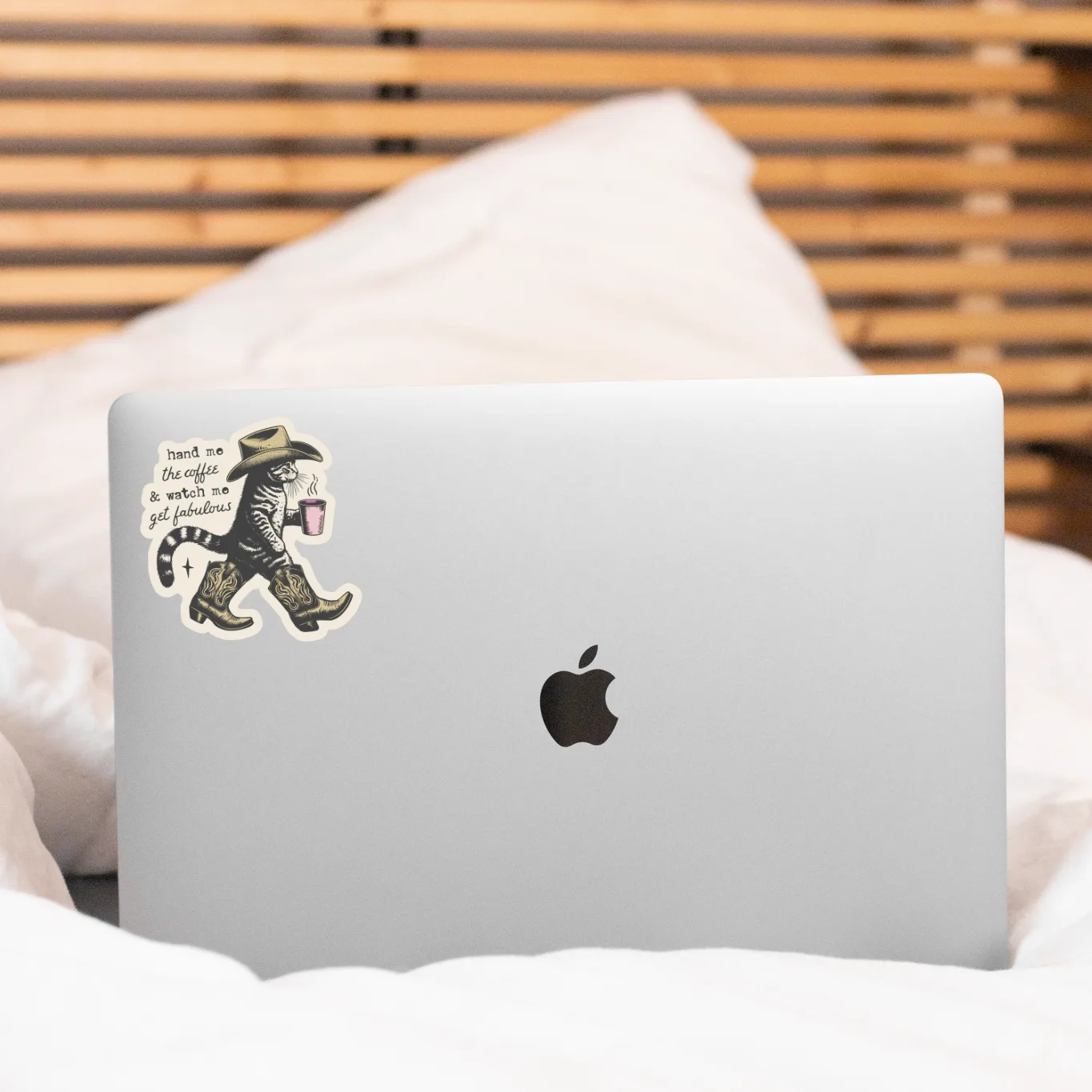 Laptop with a sticker on a bed