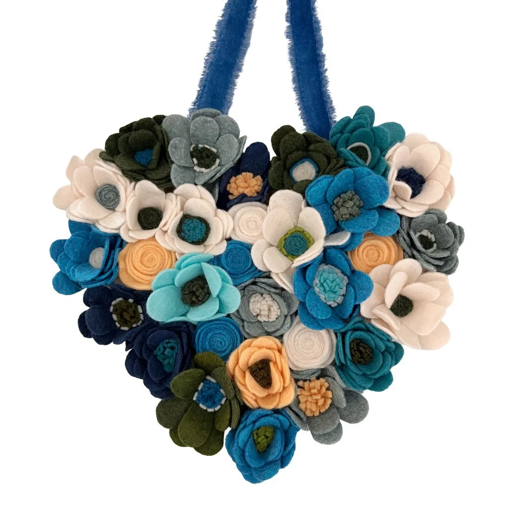 Floral-patterned heart with blue on a white background