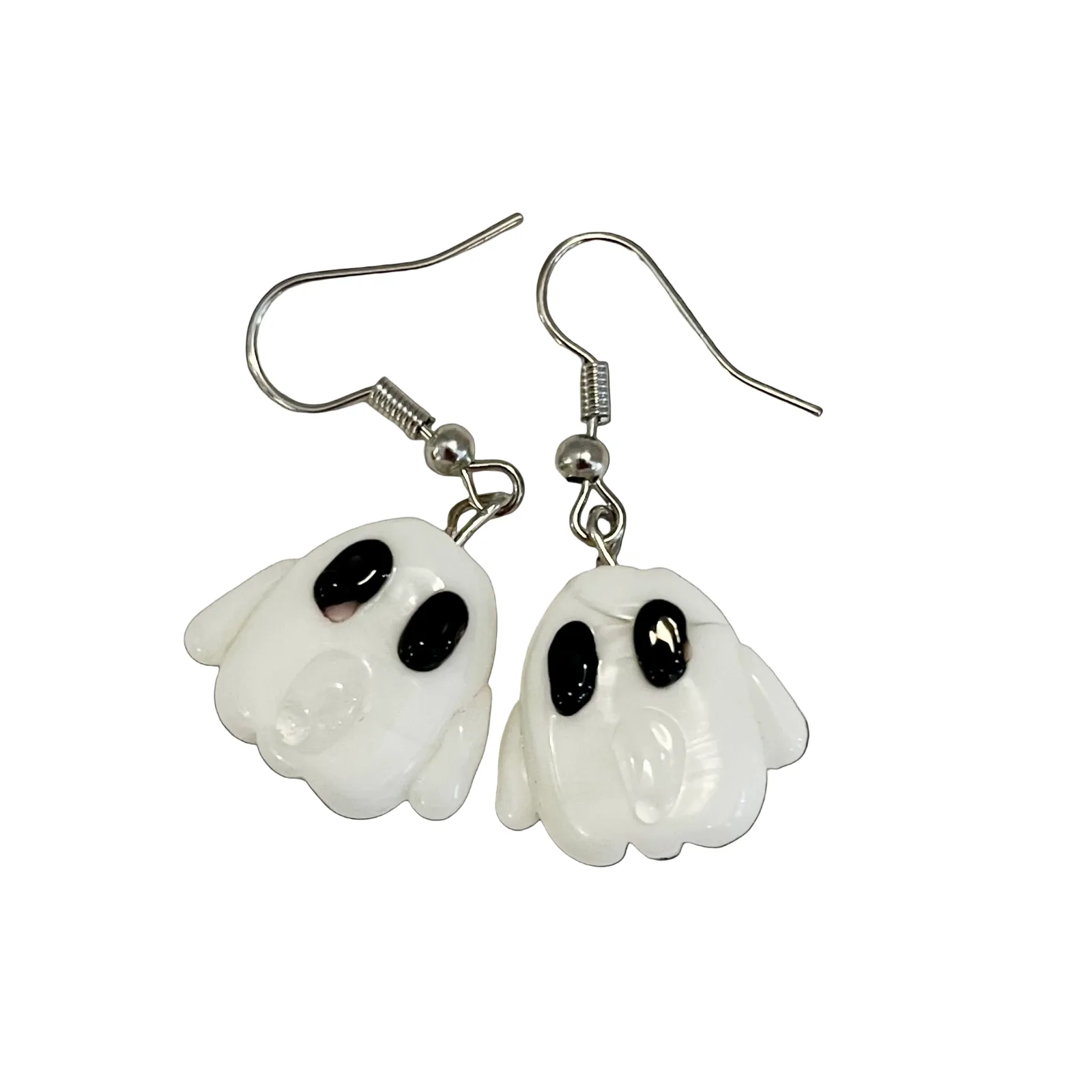Ghost-shaped earrings on a black background