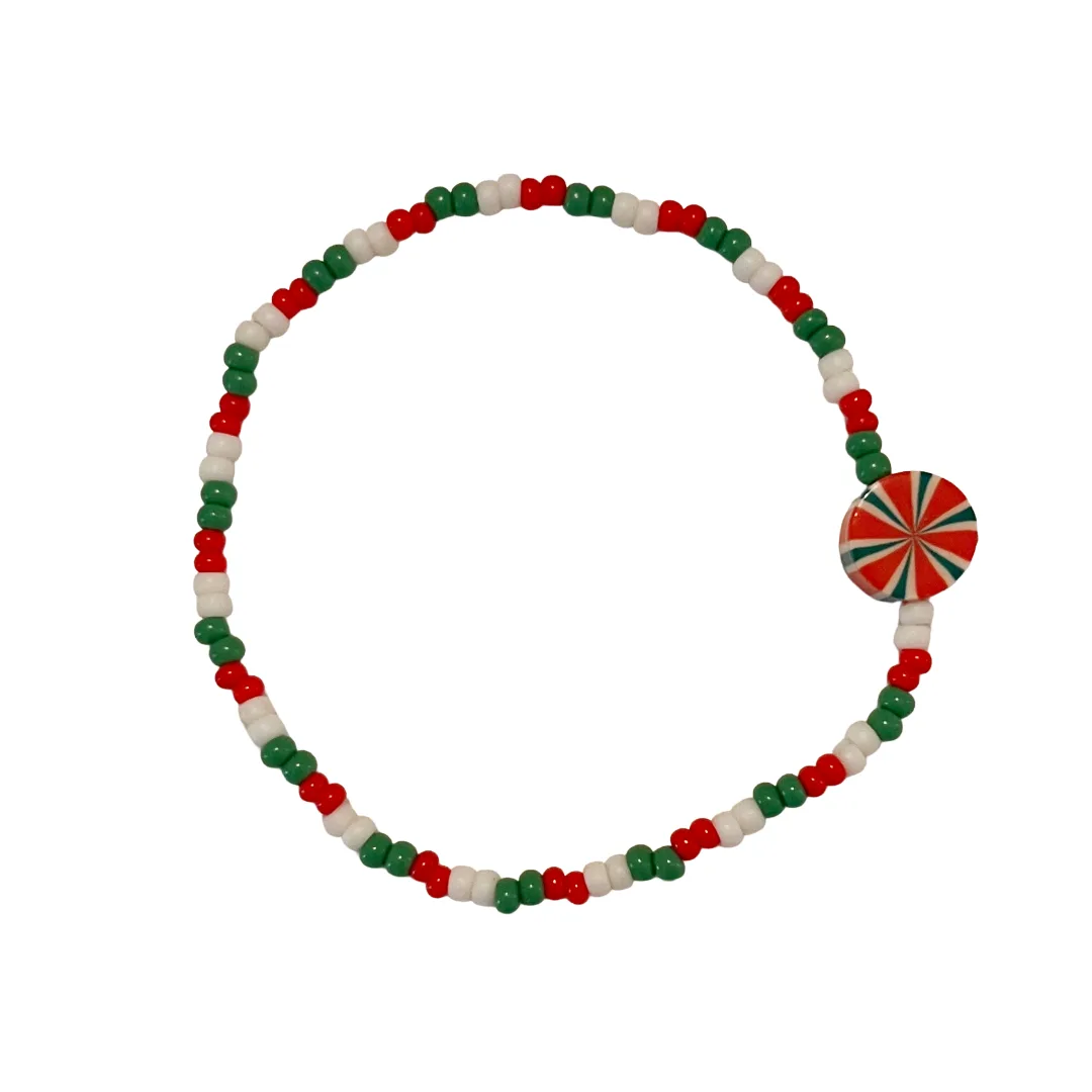 Beaded bracelet with red, green, and white beads on a white background