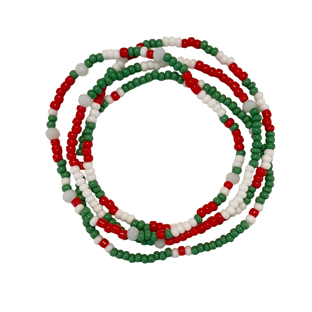 Four beaded bracelets in red, green, and white on a white background