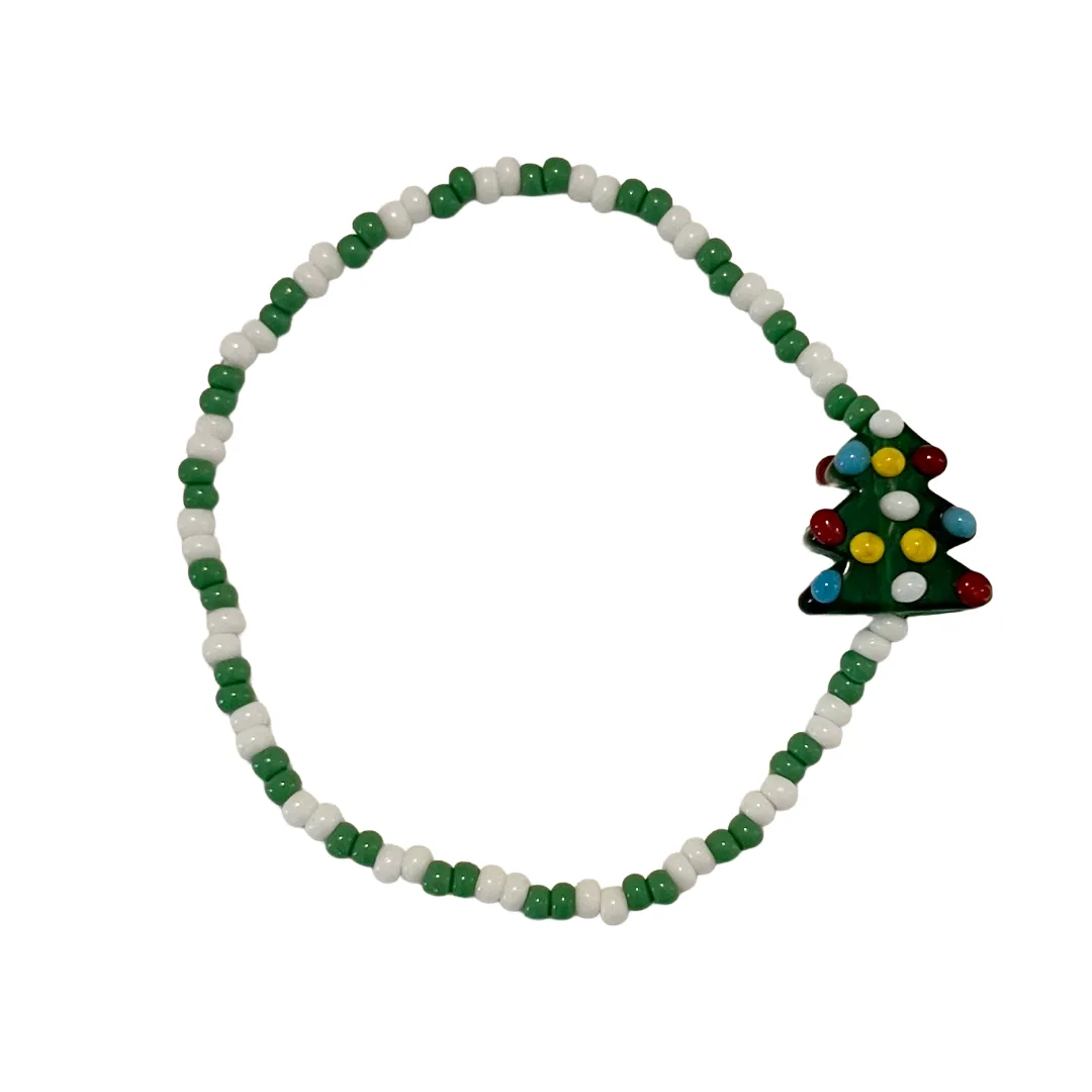 Beaded bracelet with a Christmas tree charm on a white background