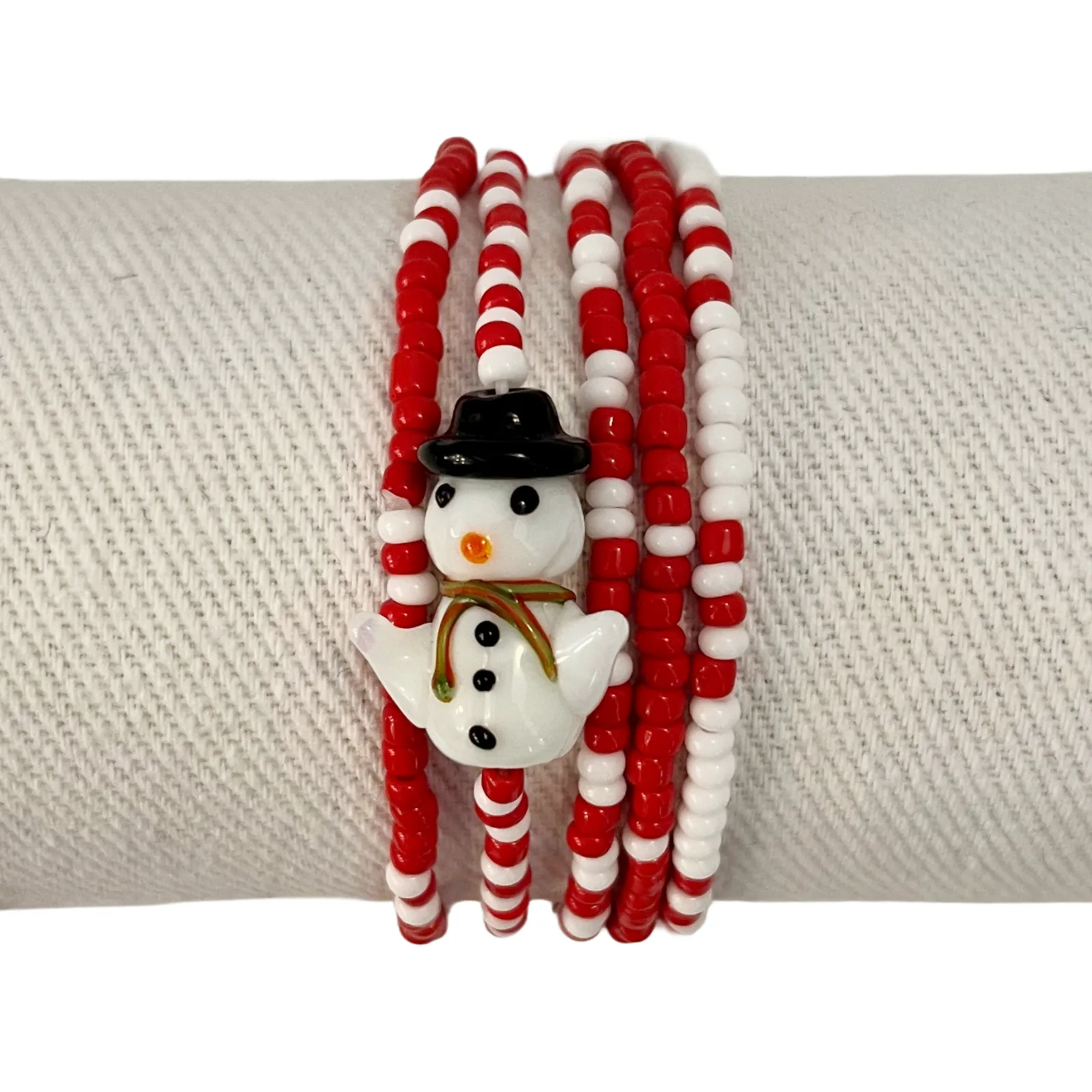 Set of beaded bracelets with snowman design on a white background