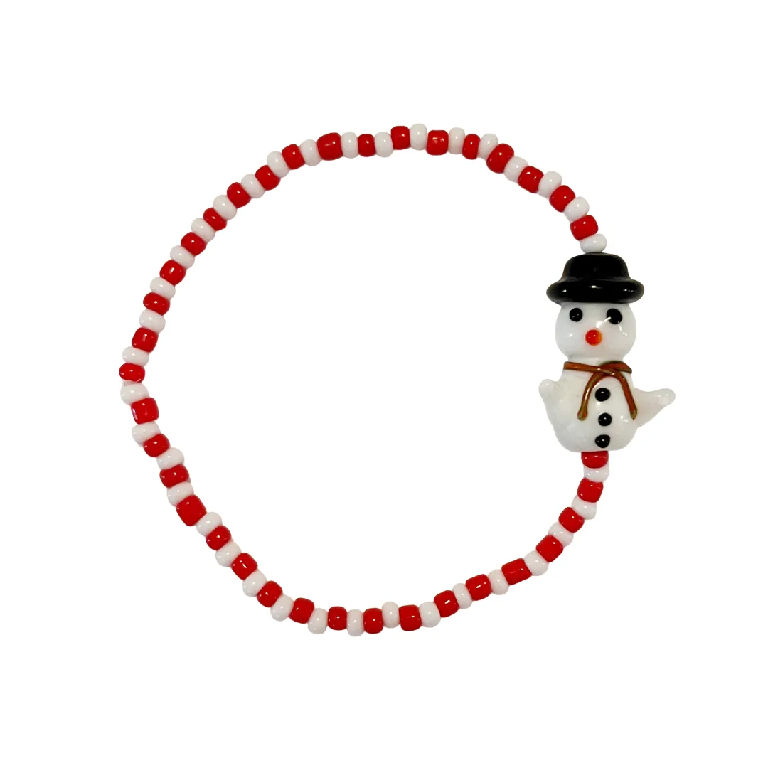Beaded bracelet with a snowman charm on a white background