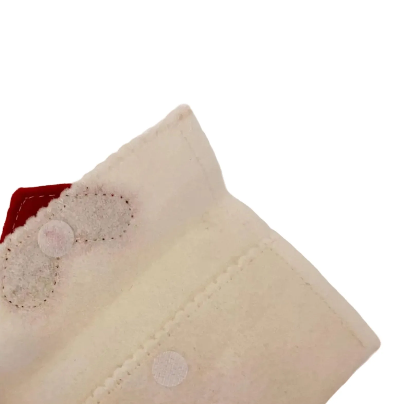 Close-up of a cream fabric with a button on a white background