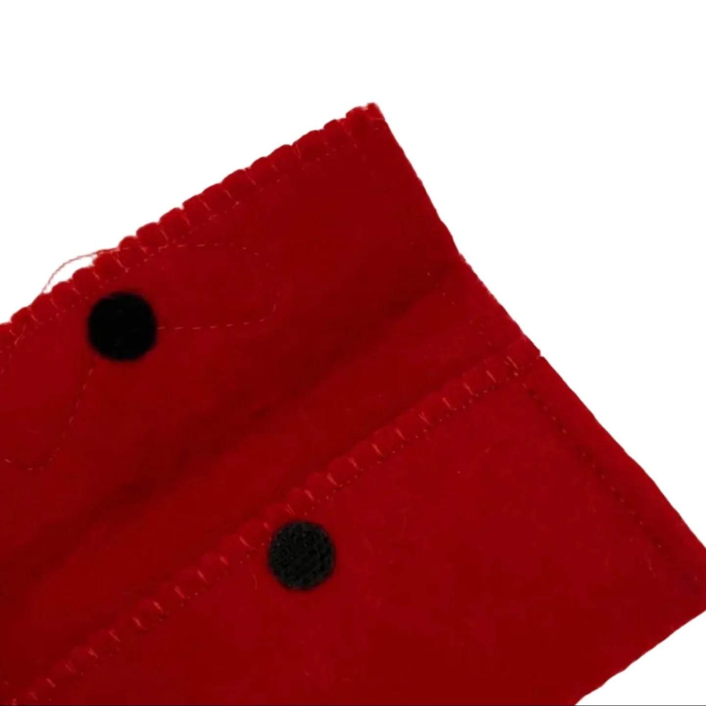 Close-up of a red fabric with black buttons on a white background