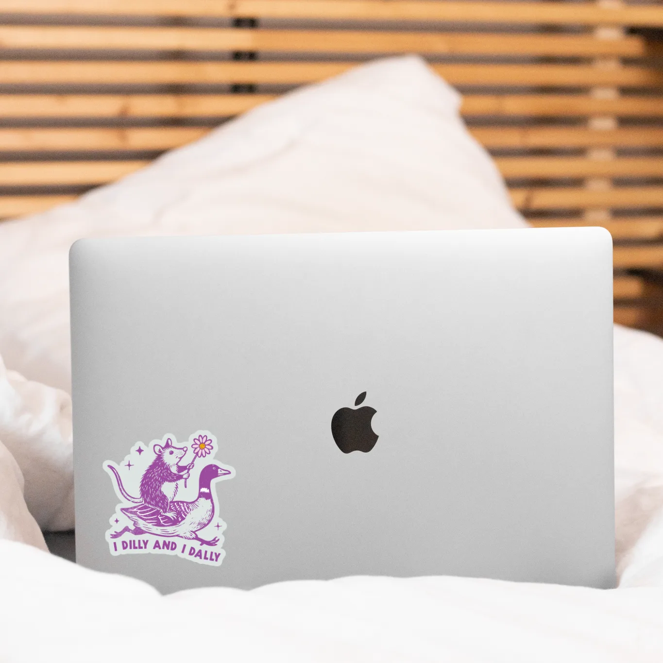 Laptop with a sticker on a bed